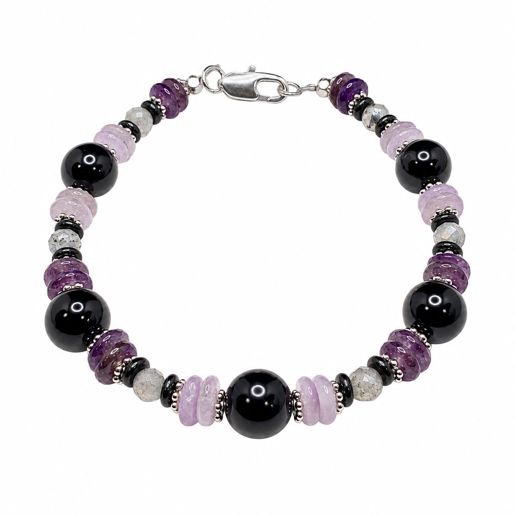 Shield of Light bracelet with black, lavender and pale pink beads and silver clasp on white background