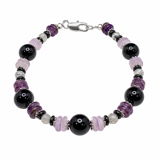 Shield of Light bracelet with black, lavender and pale pink beads and silver clasp on white background